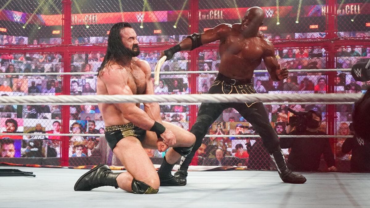 Bobby Lashley swinging a kendo stick at Drew McIntyre inside WWE Hell in a Cell