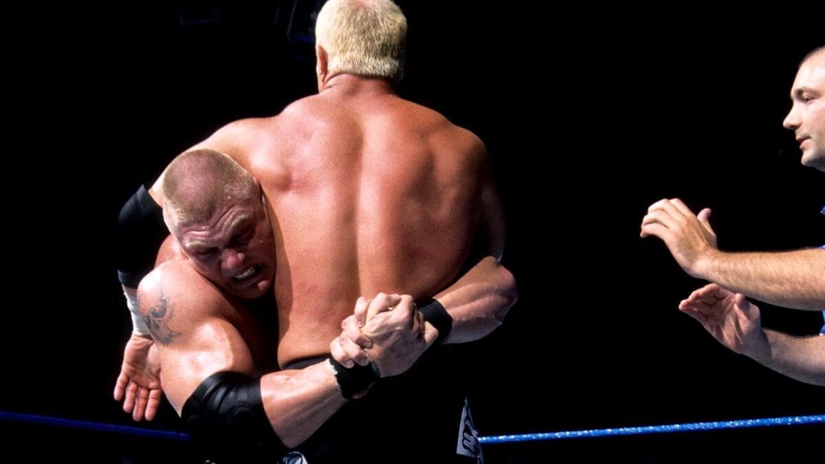 Brock Lesnar with a bearhug wrapped around Hardcore Holly's waist