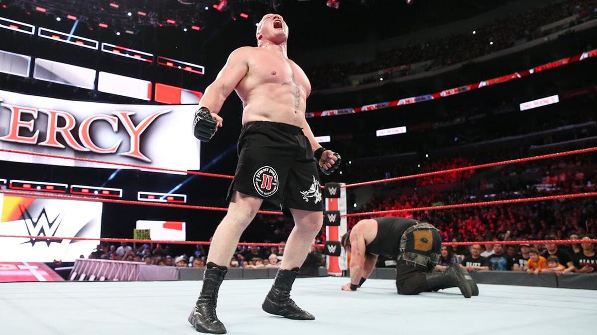 Brock Lesnar roaring as Braun Strowman crawls behind him inside the ring at WWE No Mercy 2017