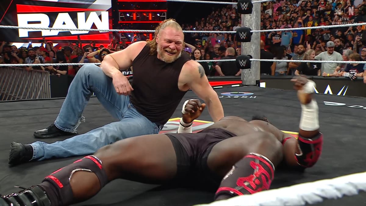 Brock Lesnar laughing at a prone Oba Femi on WWE Raw