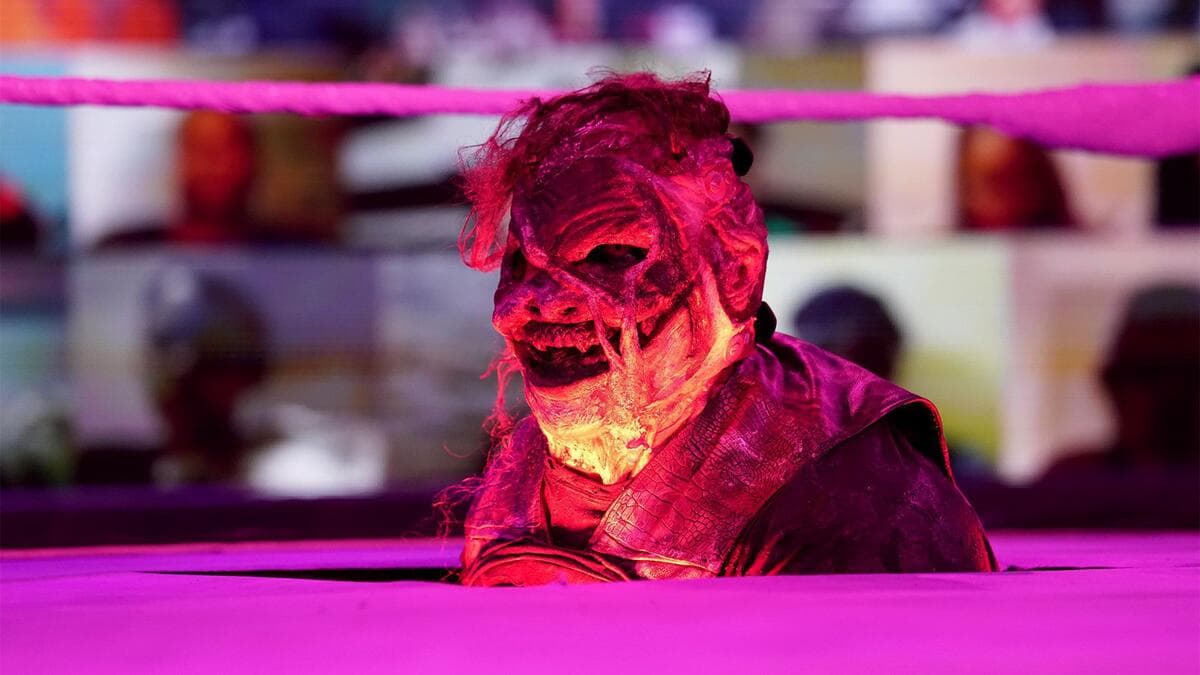 Burnt Bray Wyatt with his head stuck out from underneath the ring at WWE Fastlane 2021
