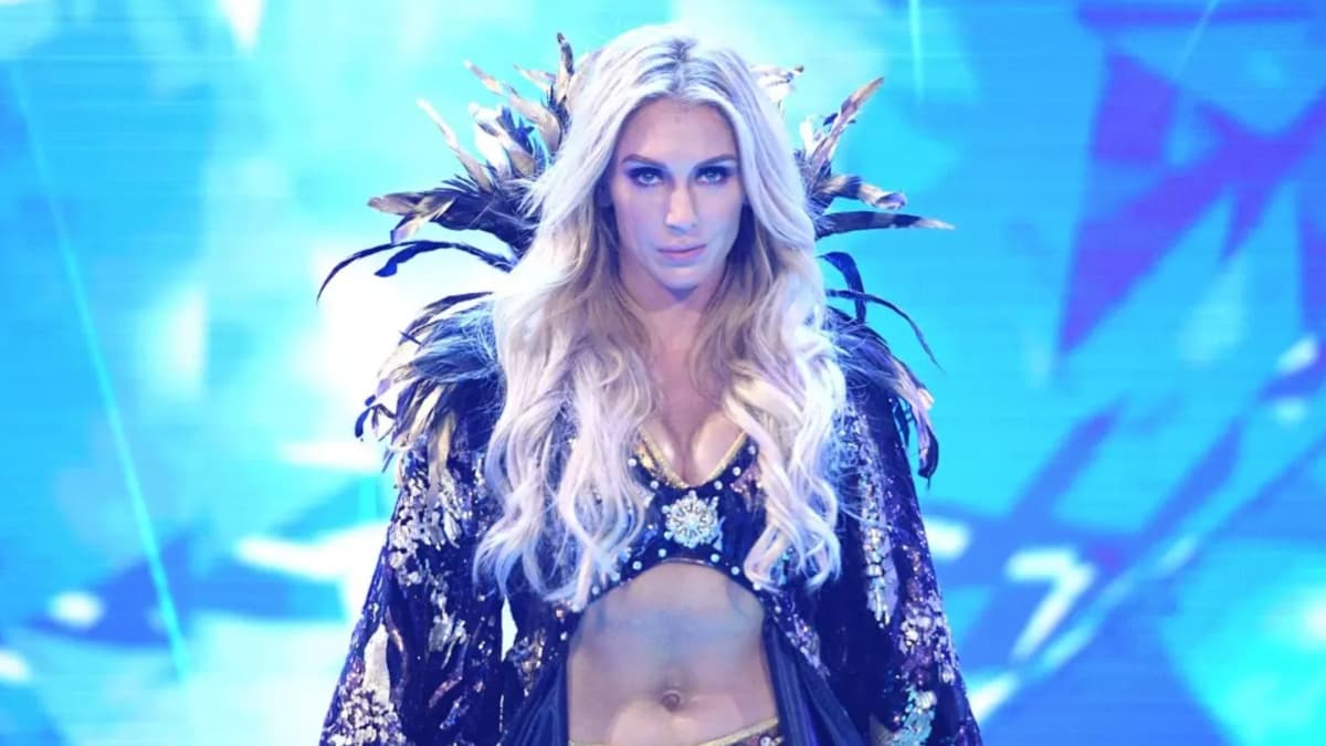 Charlotte Flair in a robe walking down the ramp 