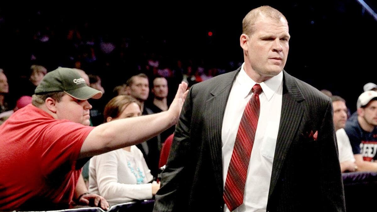 A fan pats suited Corporate Kane at a WWE event