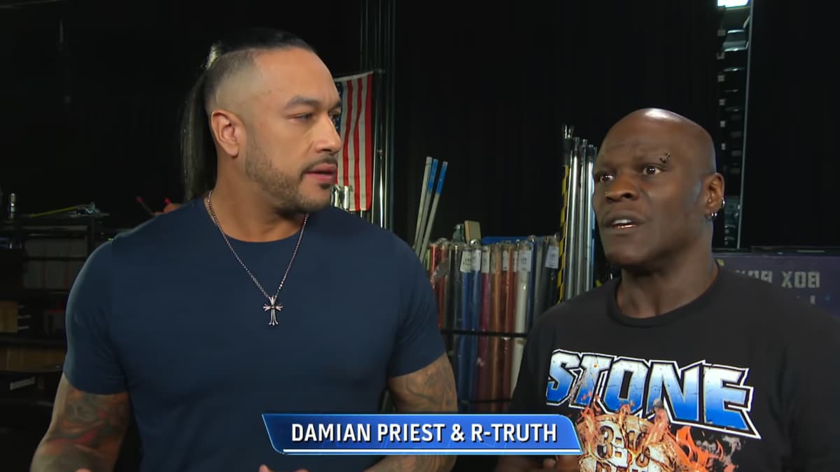 Damian Priest looking at a confused R-Truth on WWE SmackDown