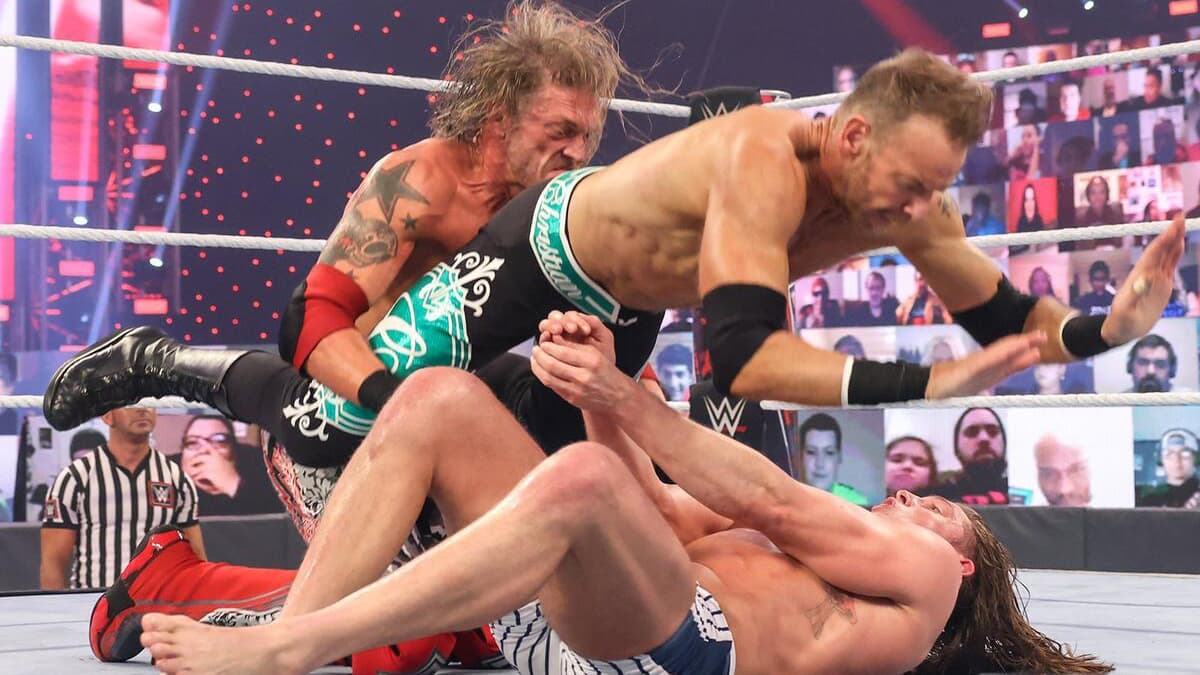 Edge and Christian hitting a double team move on Matt Riddle at Royal Rumble 2021