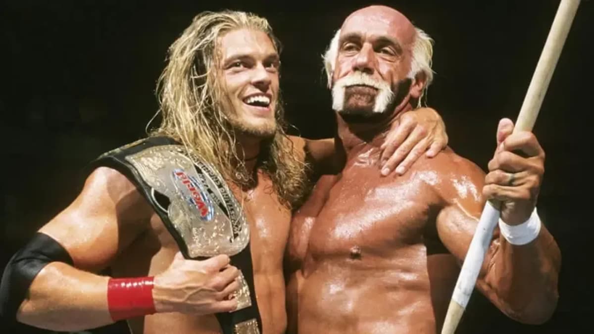 Hulk Hogan celebrating a WWE Tag Team Title win with Edge