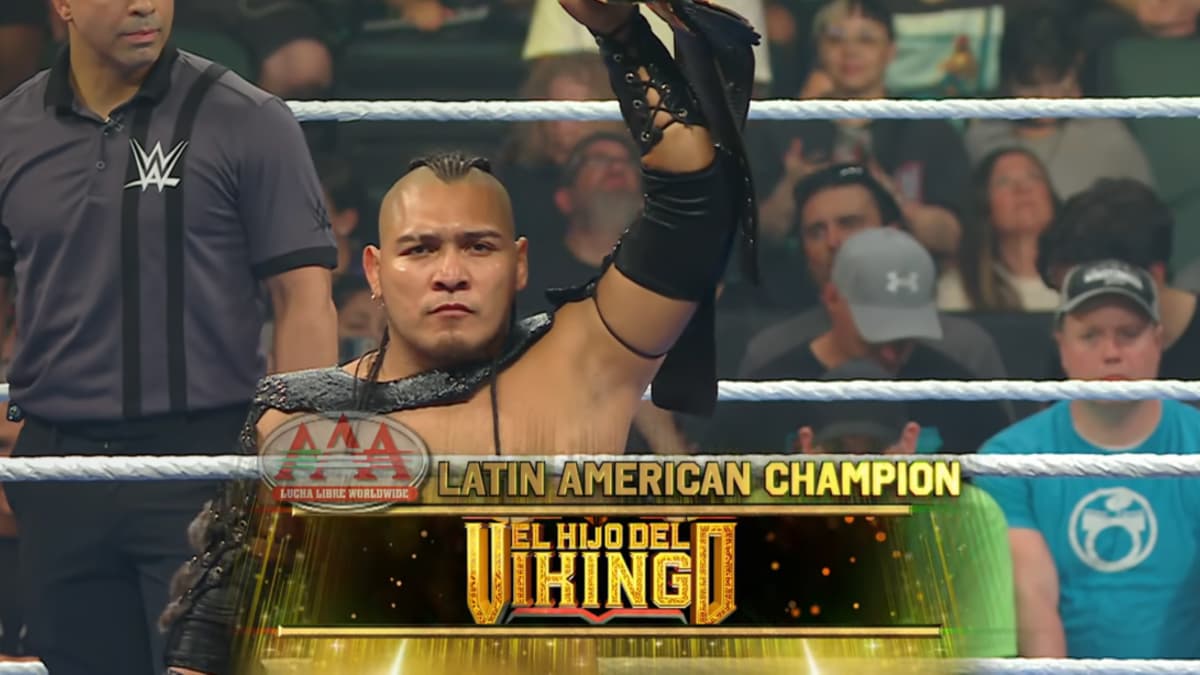 El Hijo del Vikingo holding up the AAA Latin American Title as a graphic flashes in front of him
