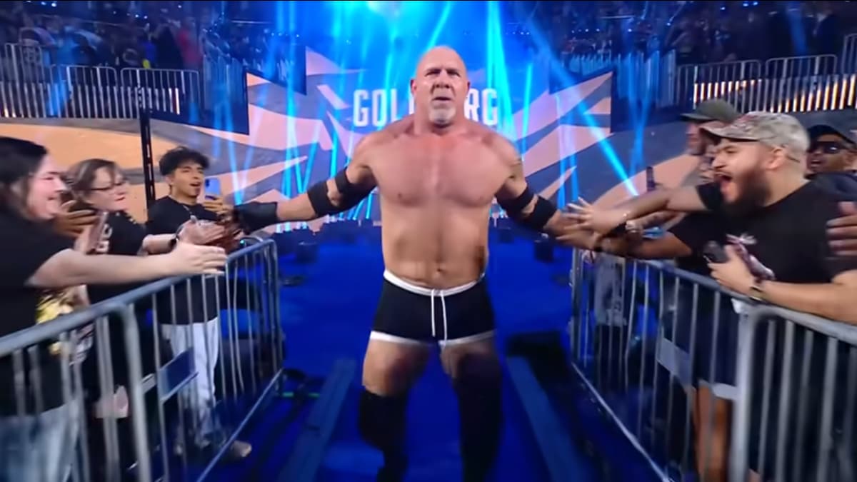 Goldberg slaps hands with fans as he walks to the ring at WWE Saturday Night's Main Event