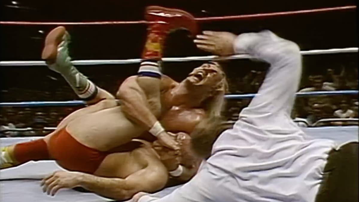 Hulk Hogan pinning the Iron Sheik as the referee counts the pin for his first WWF Title win