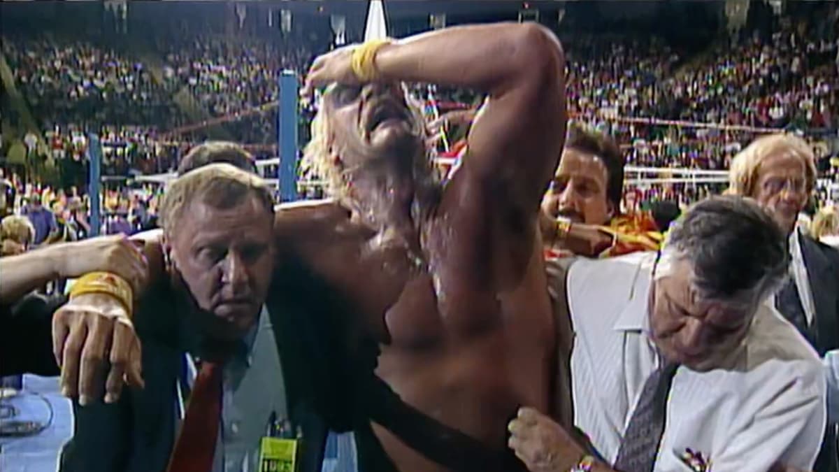Hulk Hogan being carried to the back while covering his eyes at WWE King of the Ring 1993