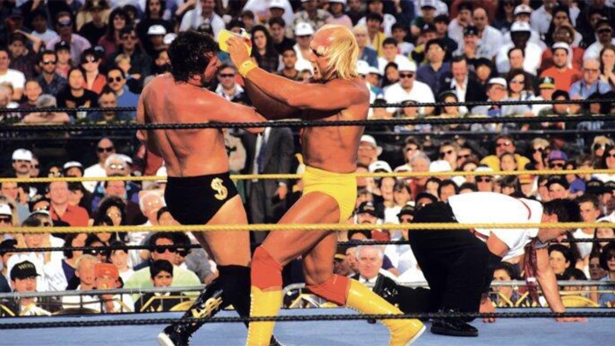 Hulk Hogan hitting Ted DiBiase with a facemsk at WWE WrestleMania IX