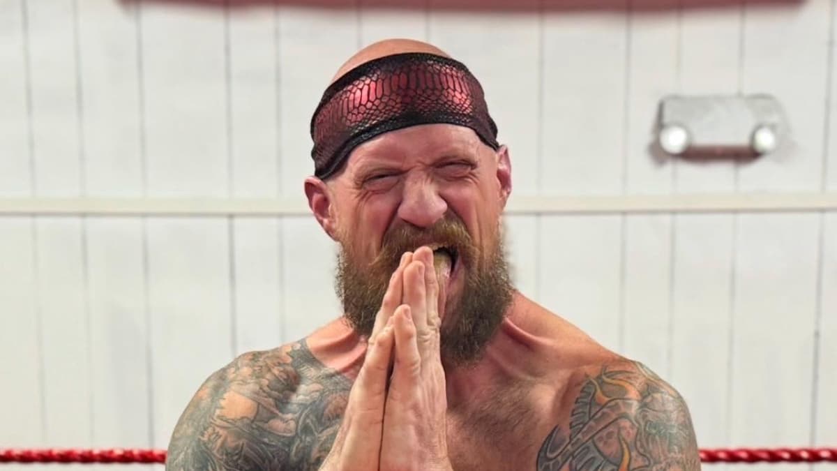 Ivan Warsaw/Knuckles Madsen gritting his teeth and putting his hands together 