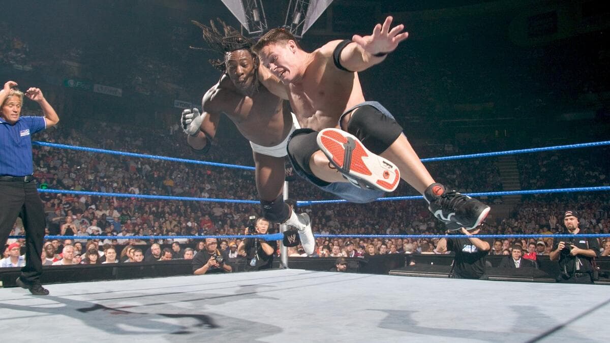 John Cena hitting a bulldog to Booker T