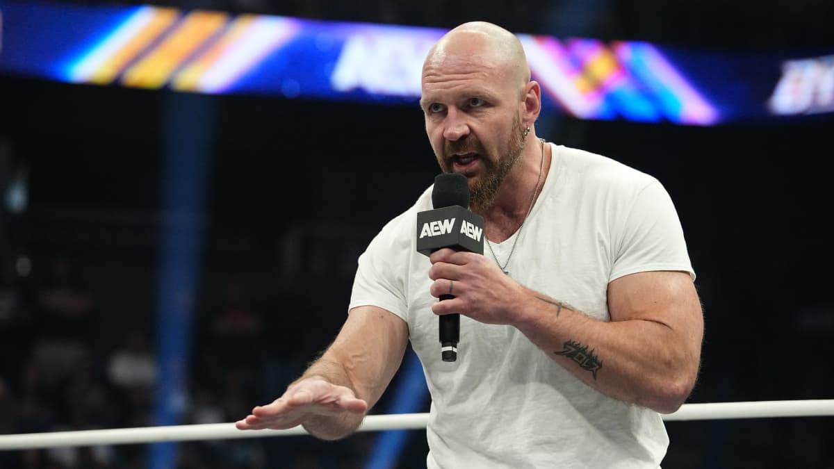 Jon Moxley cutting a promo while wearing a white t-shirt 