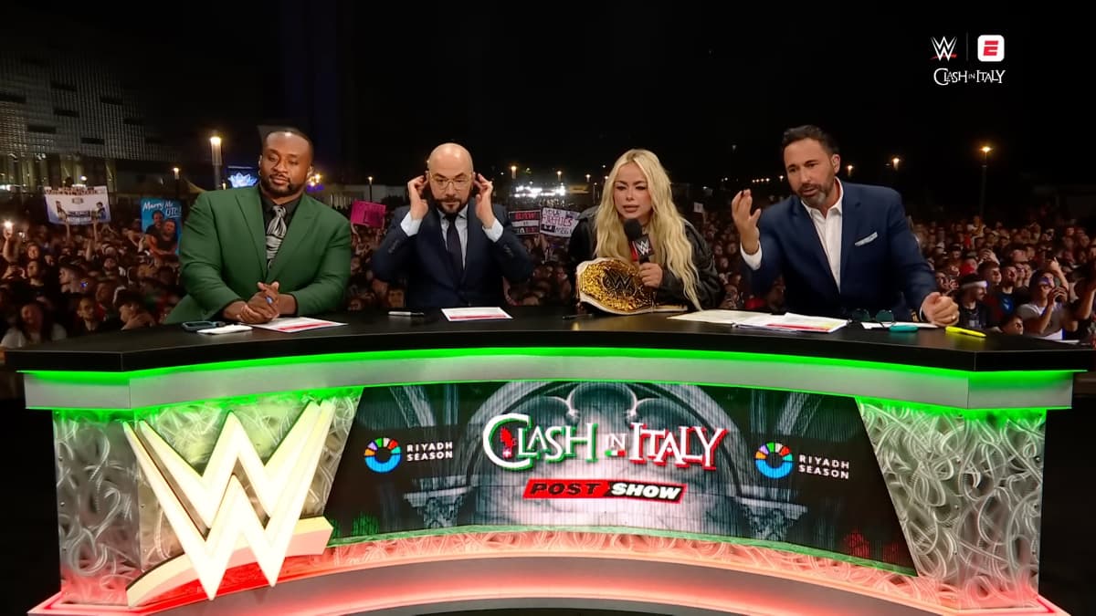 Liv Morgan looking confused alongside Big E, Pete Rosenberg, and Joe Tessitore at WWE Clash in Italy post-show