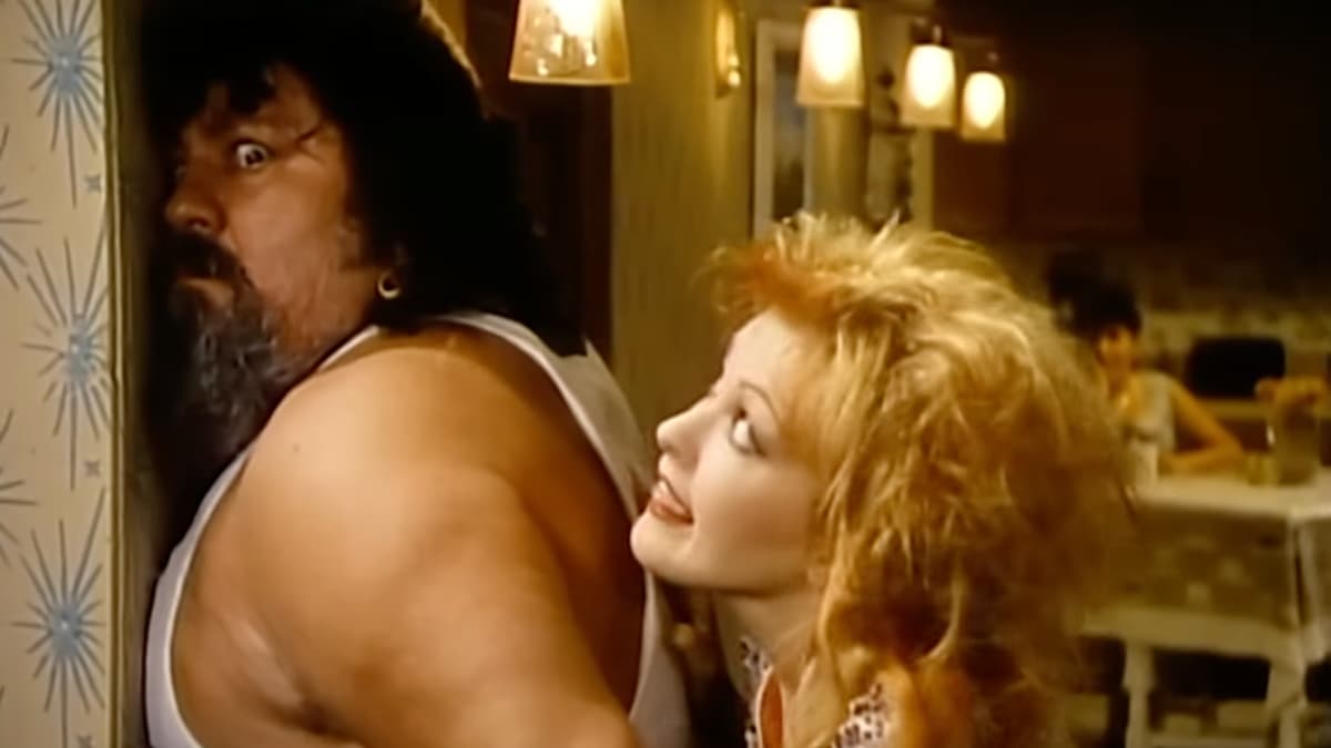 Cyndi Lauper overpowering Captain Lou Albano in Girls Just Wanna Have Fun music video
