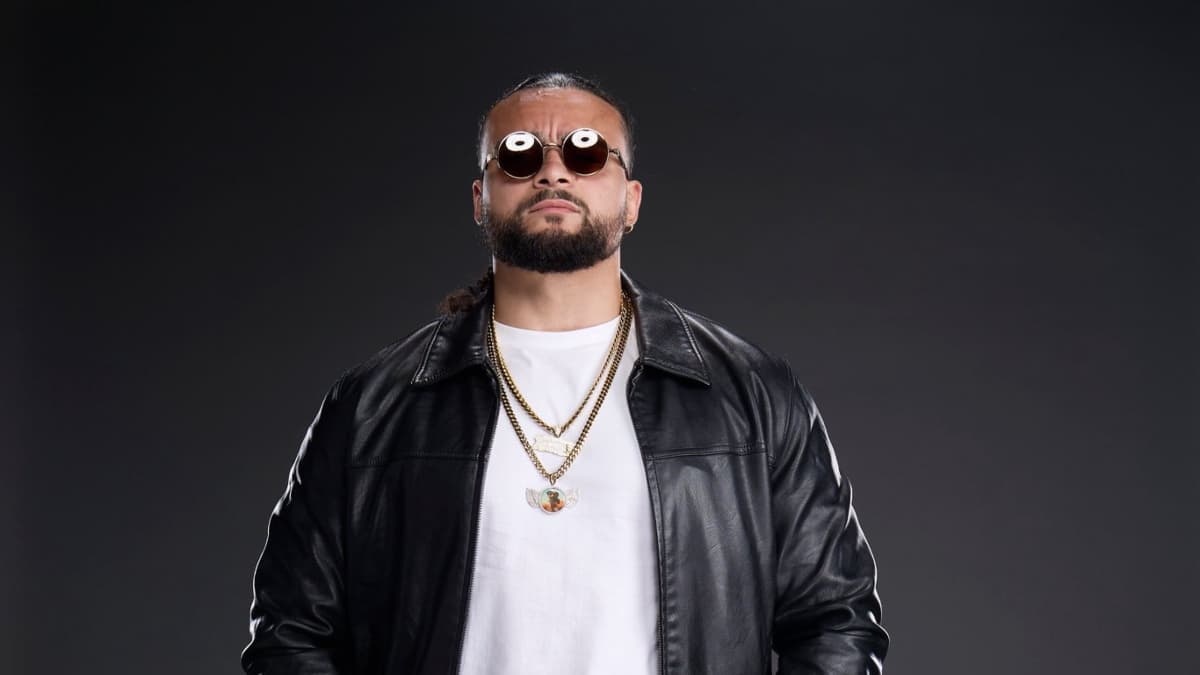 Mike Santana wearing sunglasses and leather jacket in WWE photoshoot