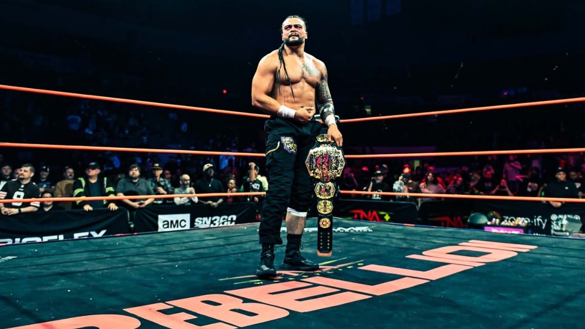 Mike Santana holding the TNA World Title in the centre of the ring following the main event Rebellion 2026