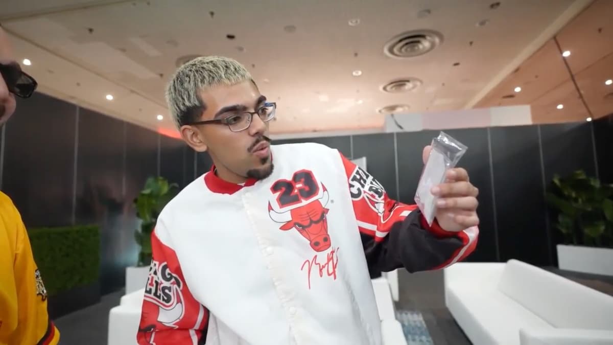 N3on holding up a Topps card