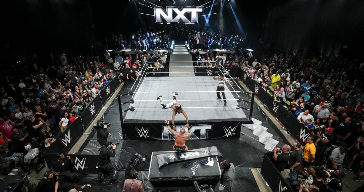 NXT set in October 2024 with Je'Von Evans hitting a suicide dive to Randy Orton