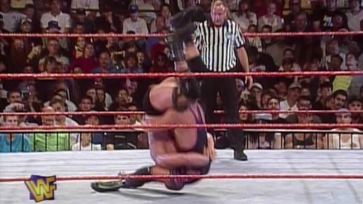 Owen Hart hitting a sit-out piledriver to Steve Austin at WWE SummerSlam 1996