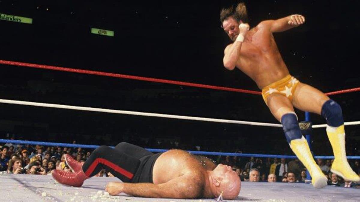 Randy Savage hitting an elbow drop to George Steele at WrestleMania 2