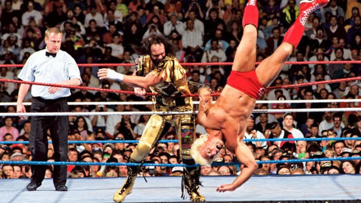 Randy Savage clotheslining Rlc Flair over the top rope at WrestleManaia VIII