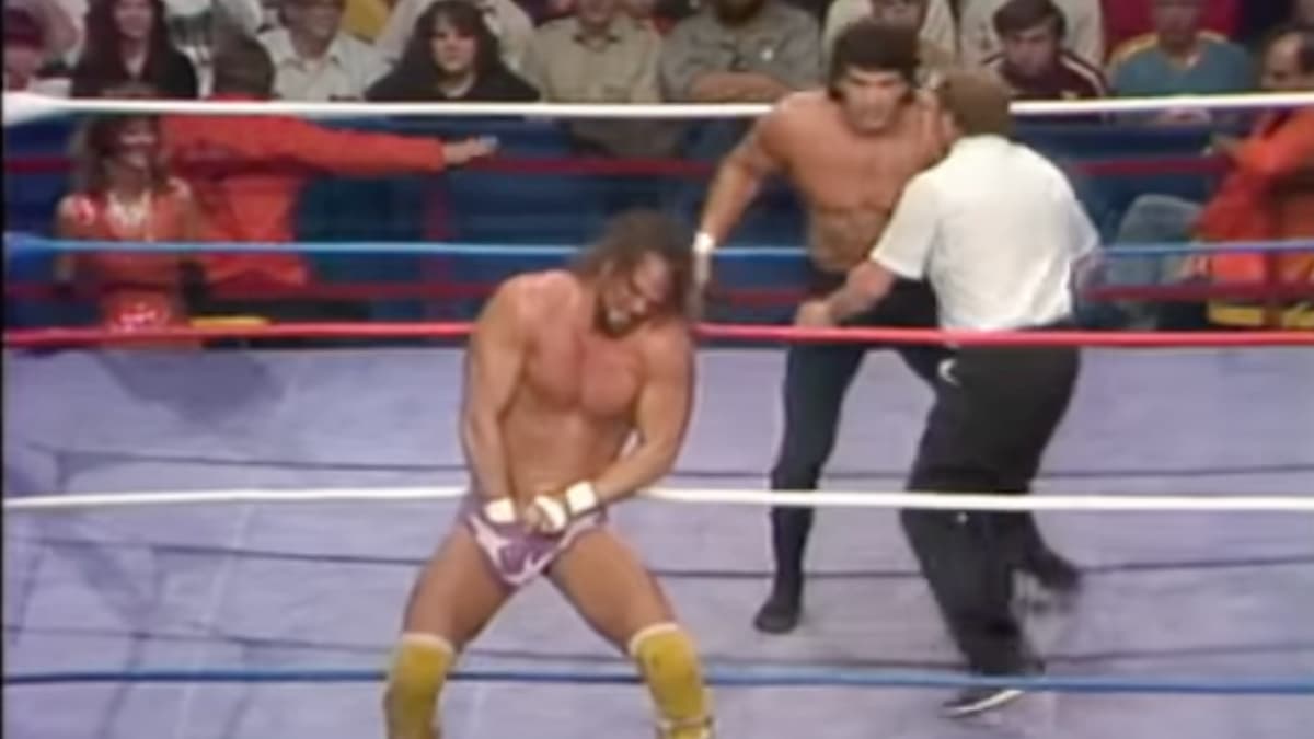 Randy Savage with his hands down his underpants as Ricky Steamboat watches on at WWF The Wrestling Classic