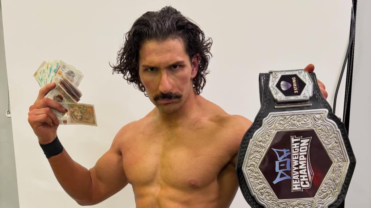 Richard Holliday holding a title belt and money