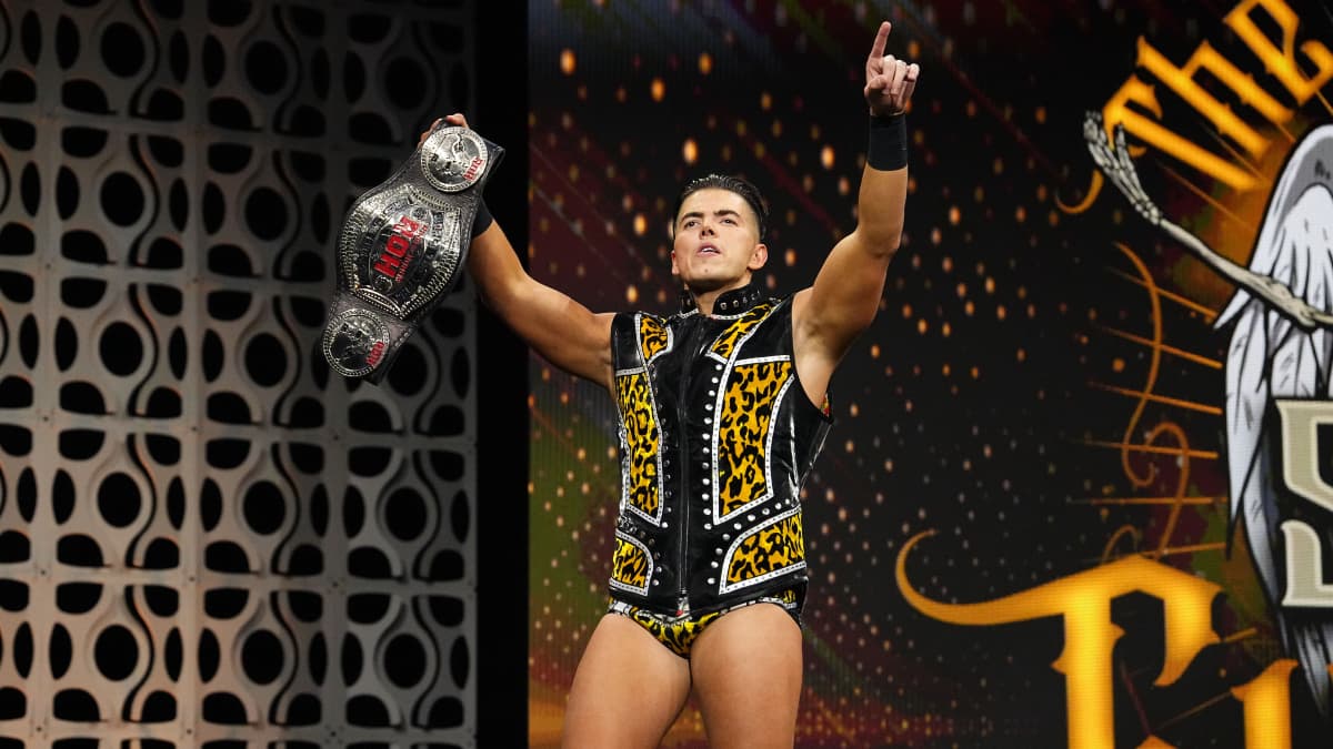 Sammy Guevara holding ROH Tag Team Titles while making his entrance on AEW Collision