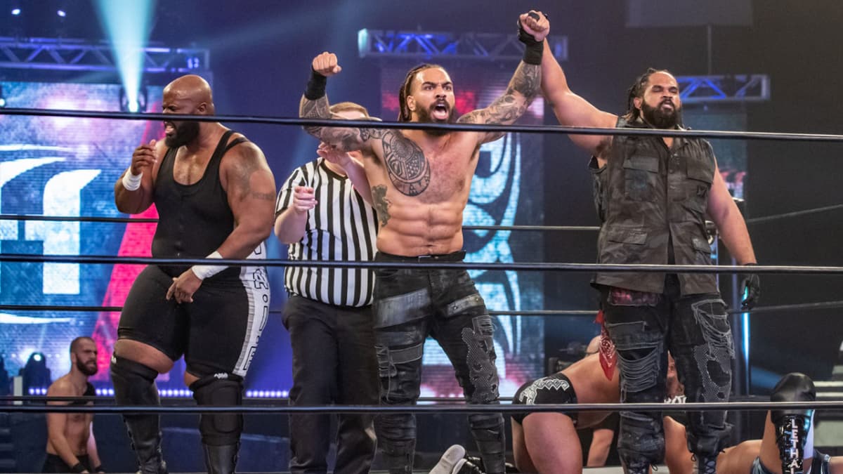Shane Taylor, Bishop Kaun, and Moses celebrating at an ROH show in 2021