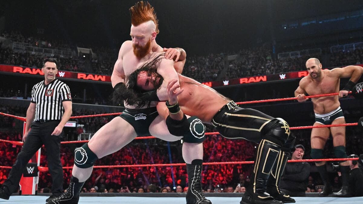Sheamus grappling with Seth Rollins as Cesaro stands on the apron on the Raw after WrestleMania 35