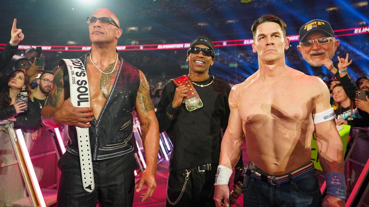 The Rock, Travis Scott, and John Cena staring menacingly from the entrance ramp at a WWE show