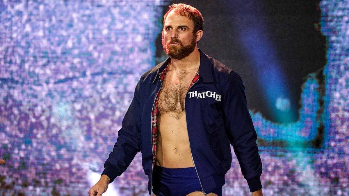 Timothy Thatcher wearing a blue jacket while scowling
