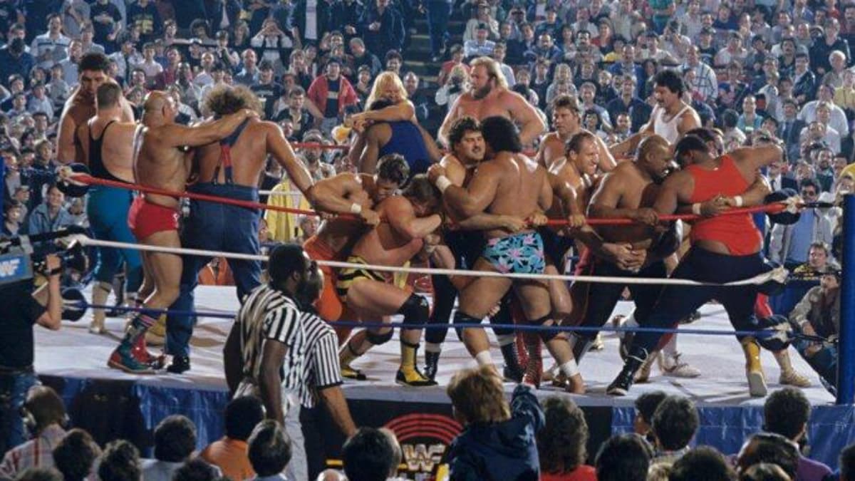 Wrestlers and NFL players brawling in WrestleMania battle royal