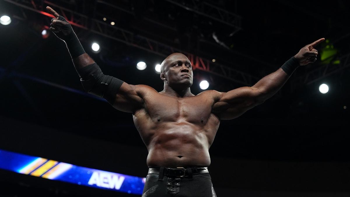 Bobby Lashley celebrating while standing on the top turnbuckle with his arms outstretched