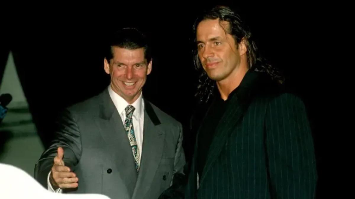 Bret Hart and Vince McMahon stood together in suits