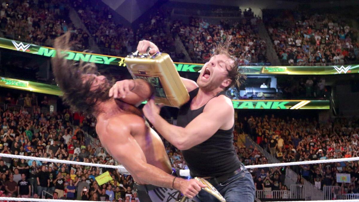 Dean Ambrose hitting Seth Rollins with the Money in the Bank briefcase at Money in the Bank 2016