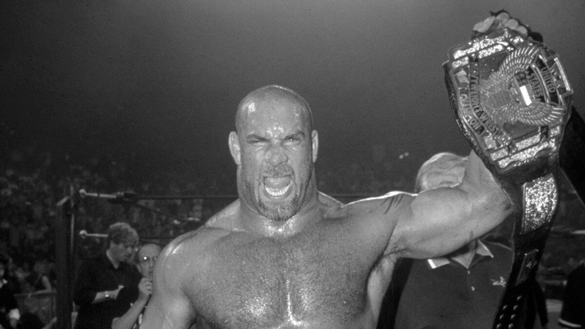 Goldberg in black and white celebrating with the WCW United States Title