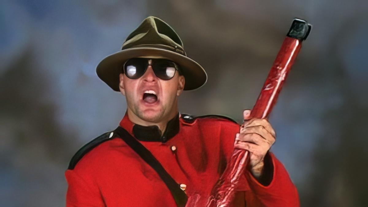 The Mountie in Mountie attire holding a red stick