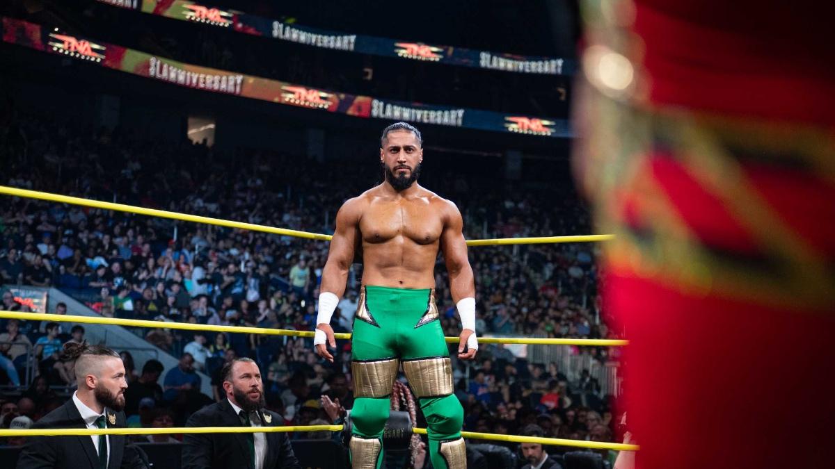 Mustafa Ali standing in the corner of a pro wrestling ring wearing green tights at TNA Slammiversary 2025