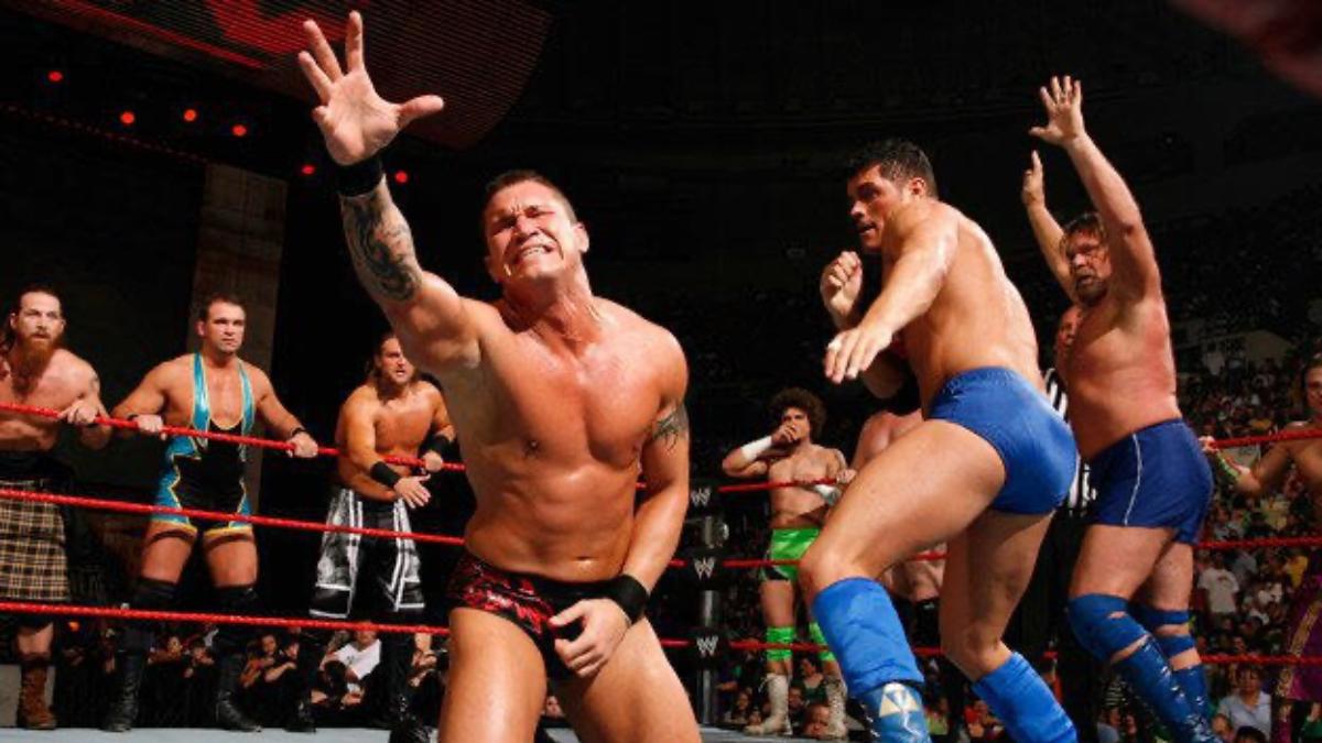 Randy Orton reaching out for a tag as Cody Rhodes prepares to punch him on WWE Raw