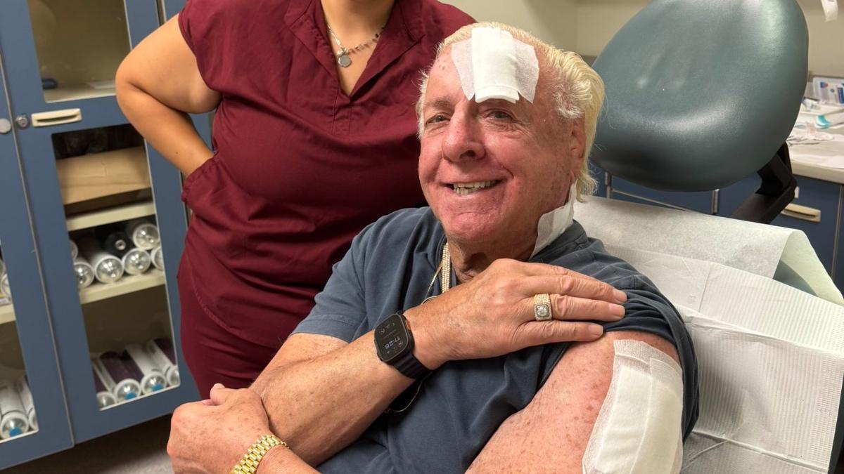 Ric Flair with big plasters on his head and arm 