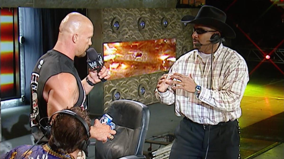 Steve Austin cutting a promo while looking at Jonathan Coachman