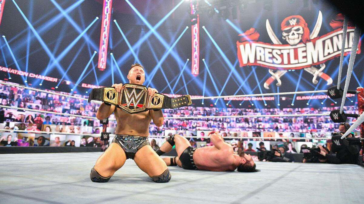 The Miz with the WWE Title as Drew McIntyre lies behind him at WWE Elimination Chamber 2021