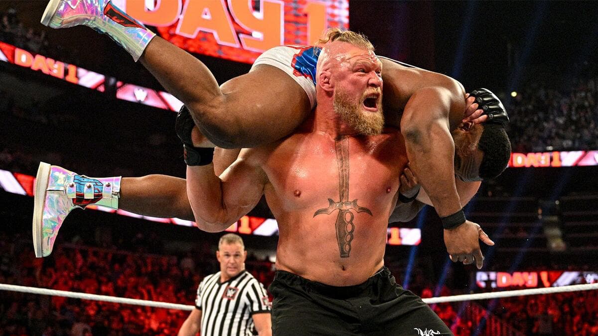 Brock Lesnar with Big E draped over his shoulders ready for an F5