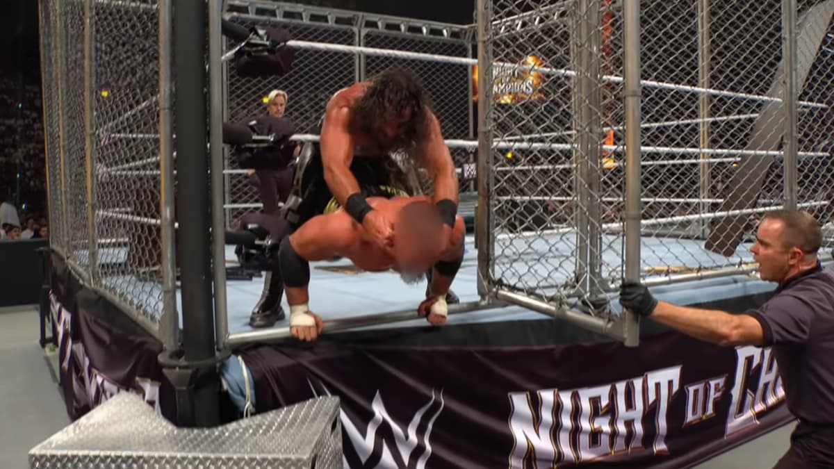 Seth Rollins stopping Bron Breakker from escaping through the door but Breakker has a blurred out face