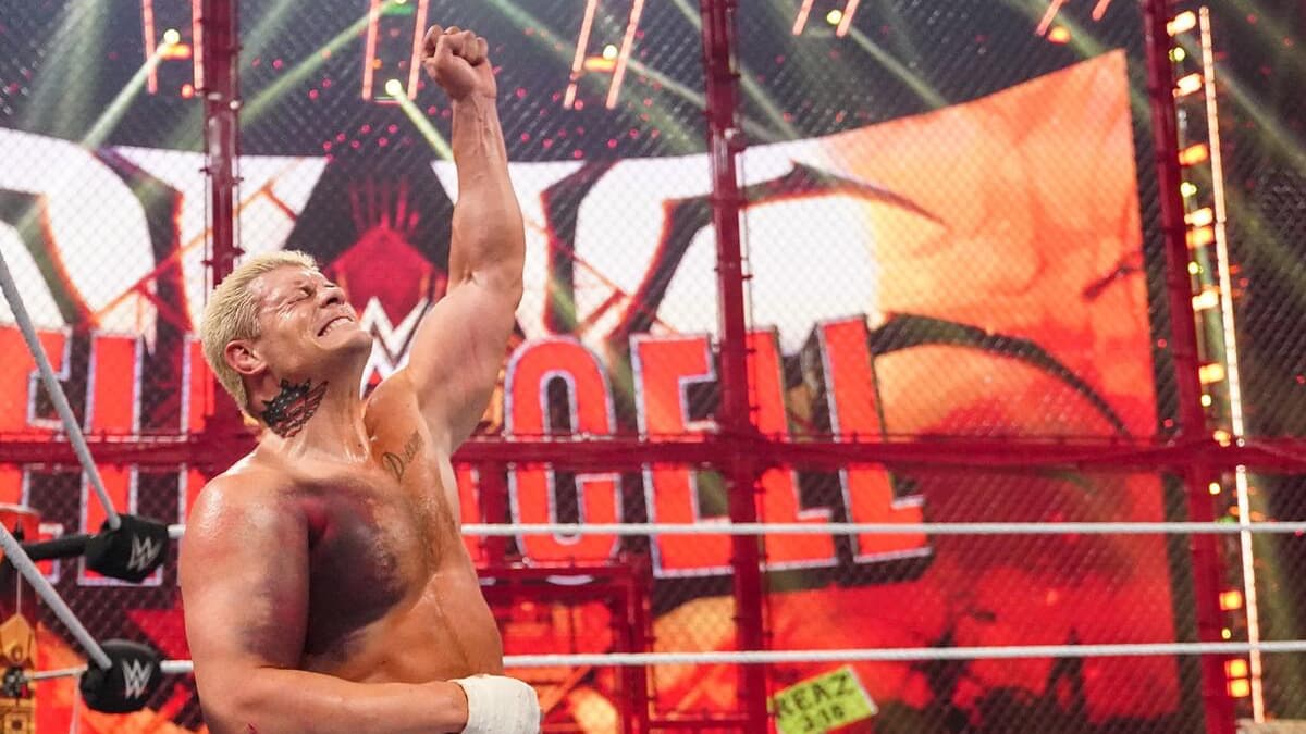 Cody Rhodes with heavy bruising on his right arm and pec raising his left arm in victory at WWE Hell in a Cell 2022