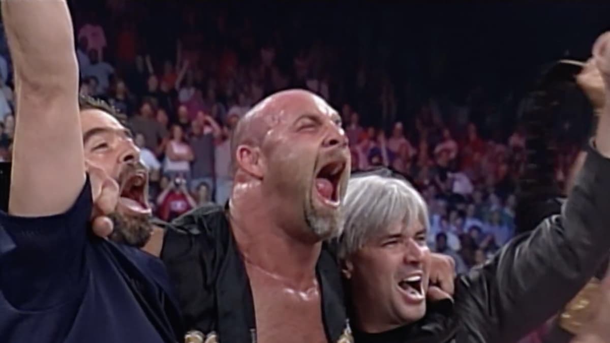 Goldberg screaming with his shoulders over Eric Bischoff and Vince Russo
