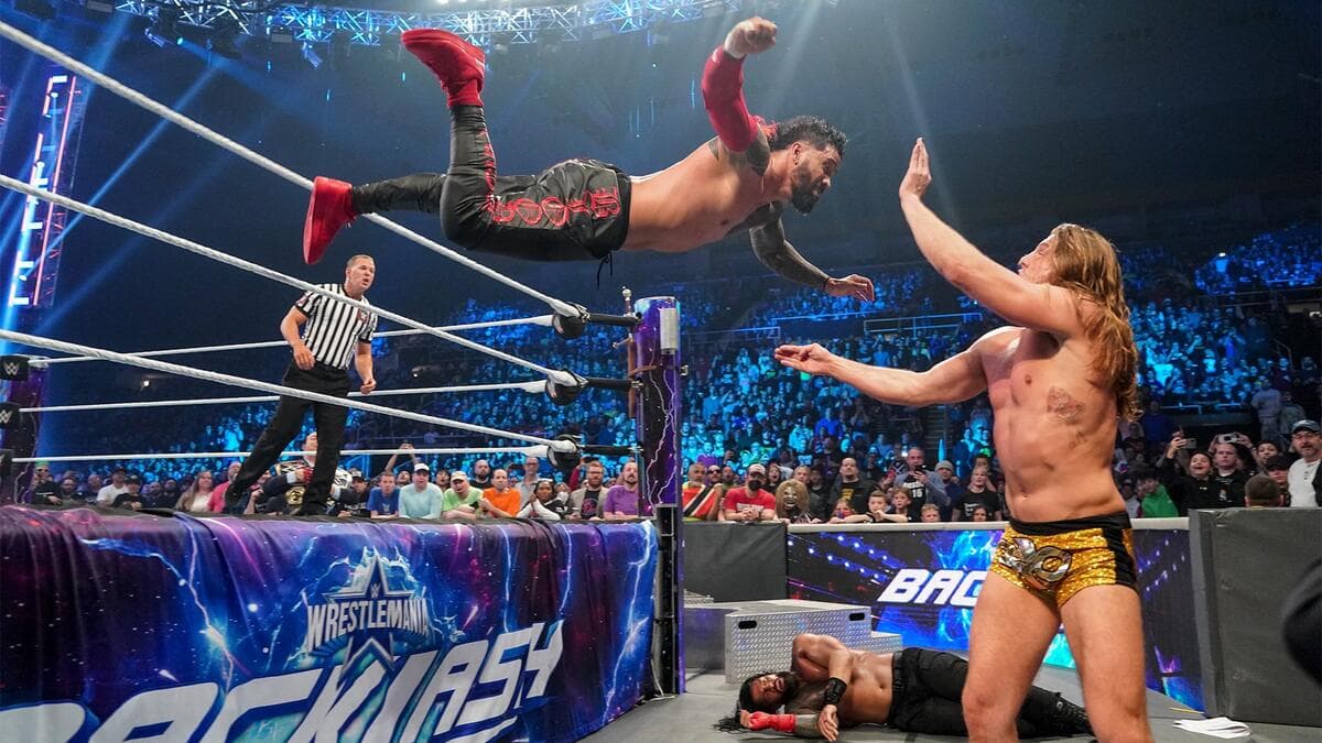 Jey Uso hitting a suicide dive to Matt Riddle at WrestleMania Backlash 2022